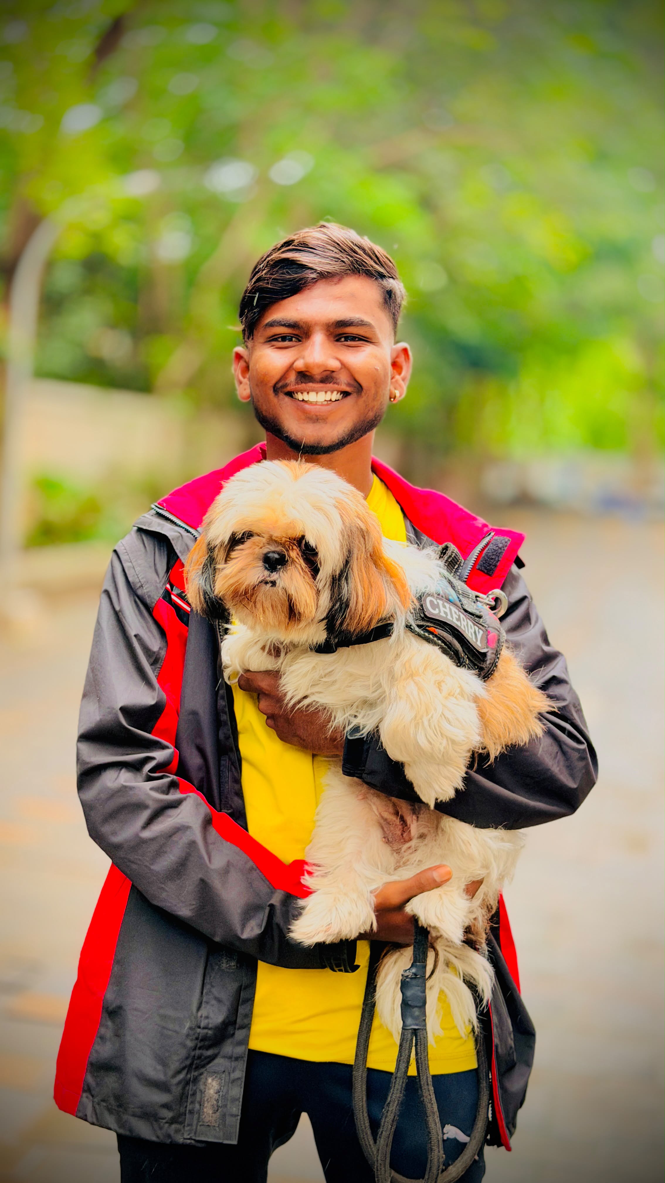 Walker holding a fluffy Shih Tzu named Cherry